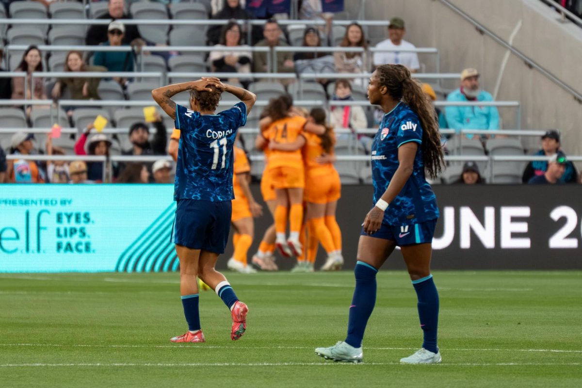 Wave players walk away in frustration as the Dash celebrate their first goal.